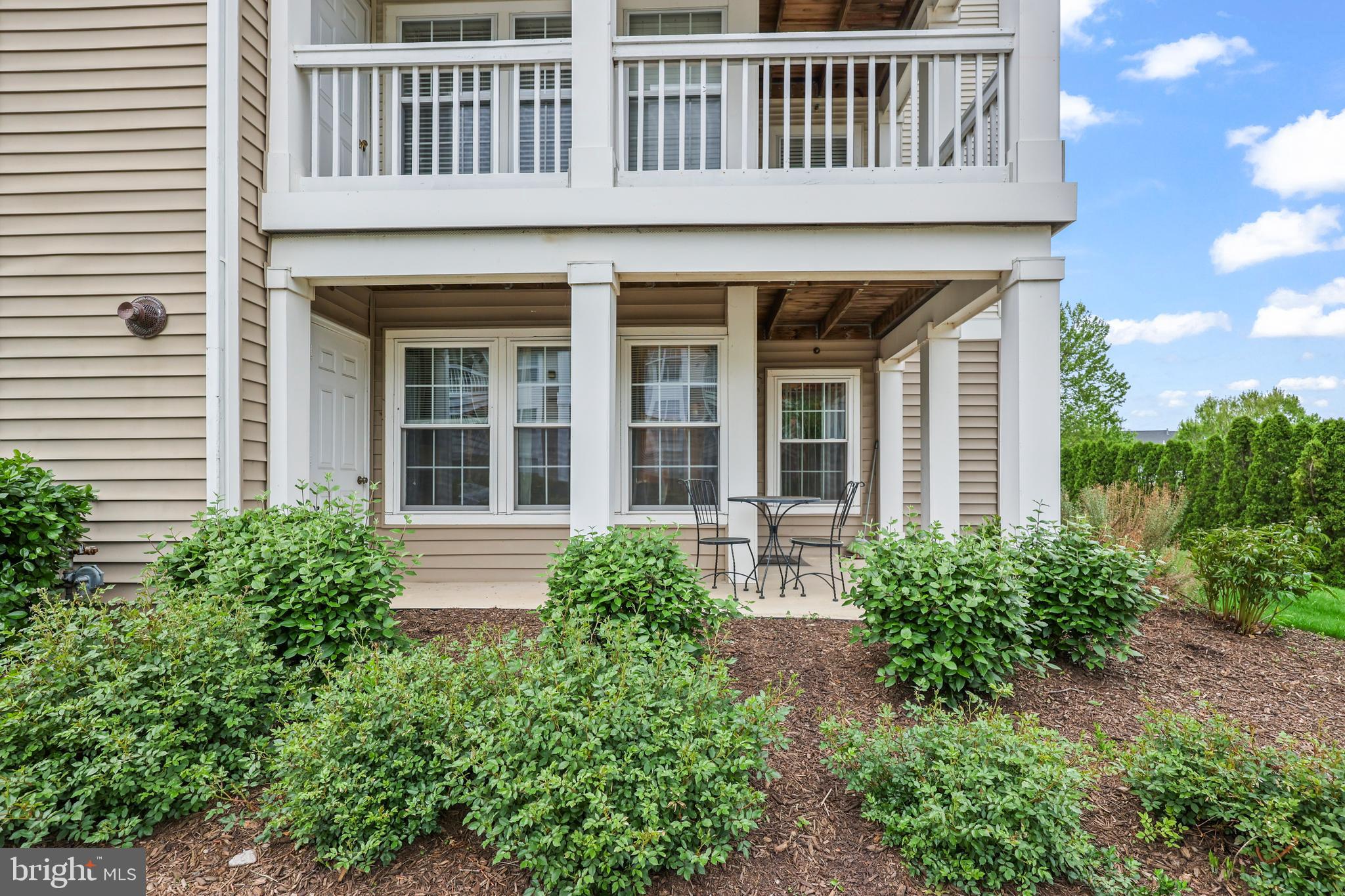 14197 Cuddy Loop, Unit 104 Woodbridge, VA 22193 - Photo 26 of 33 a front view of a house with garden and porch