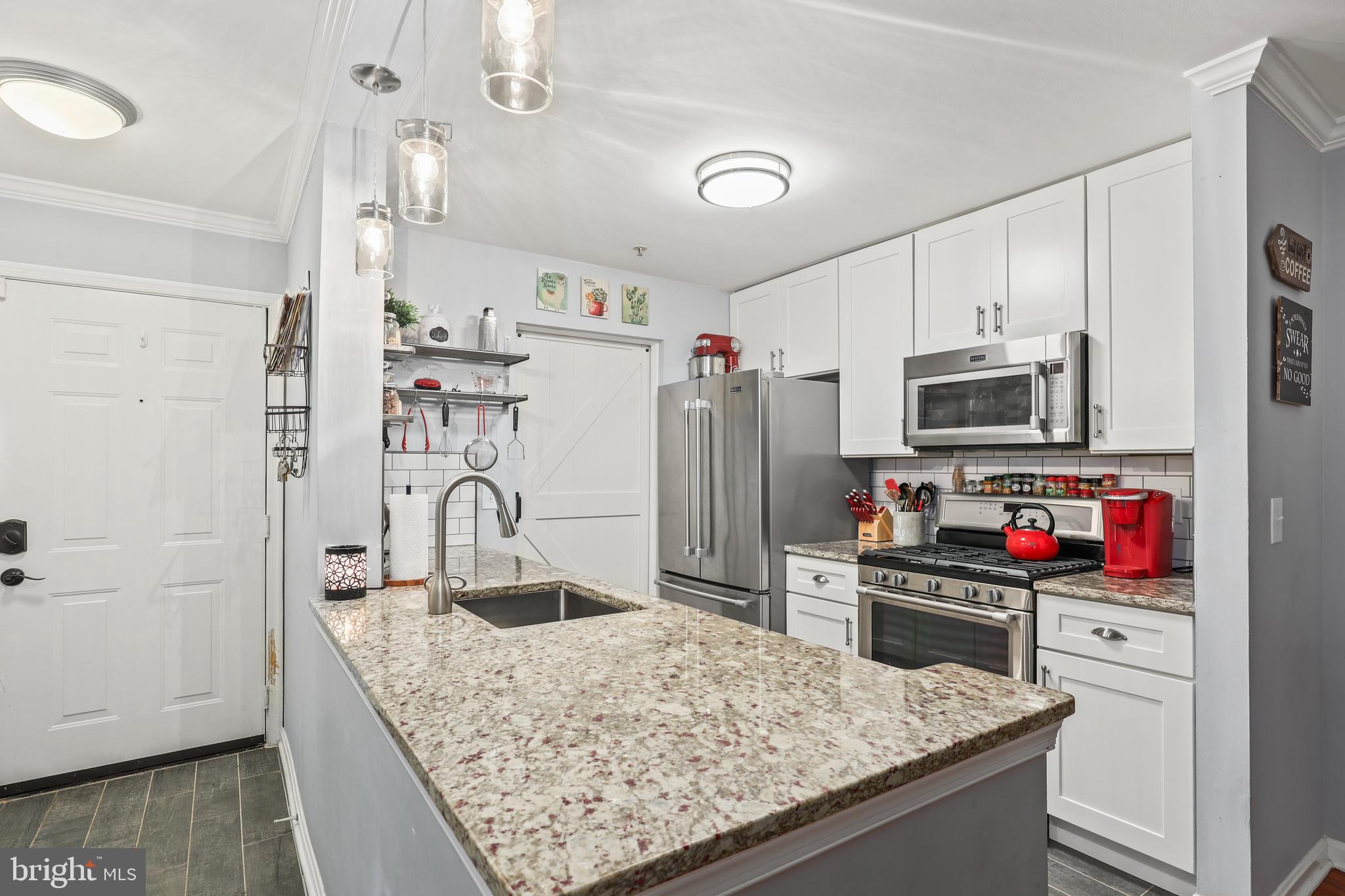 14197 Cuddy Loop, Unit 104 Woodbridge, VA 22193 - Photo 5 of 33 a kitchen with stainless steel appliances granite countertop a sink stove and refrigerator