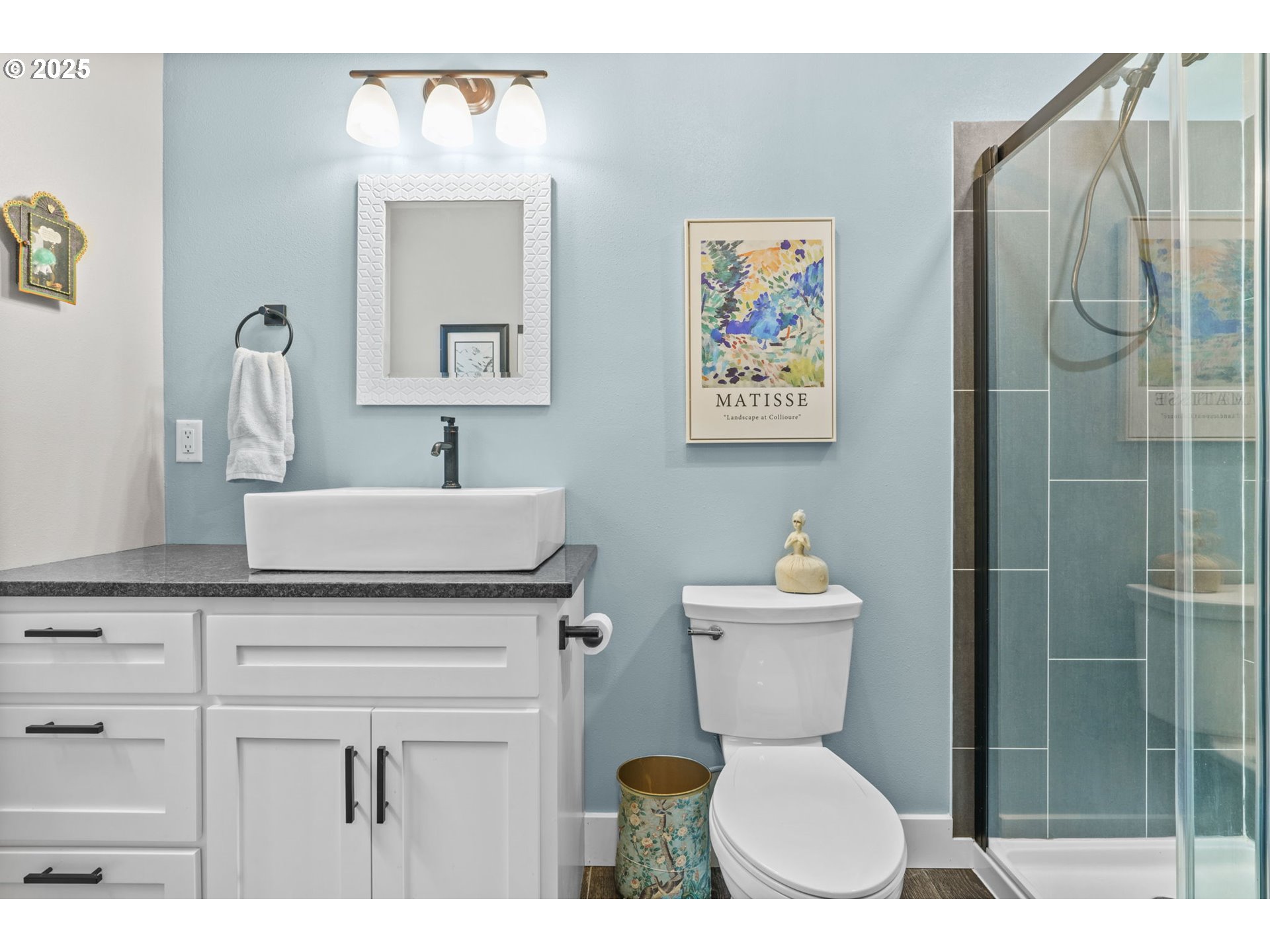 335 North H Street Cottage Grove, OR 97424 - Photo 19 of 45 a bathroom with a toilet a sink and mirror