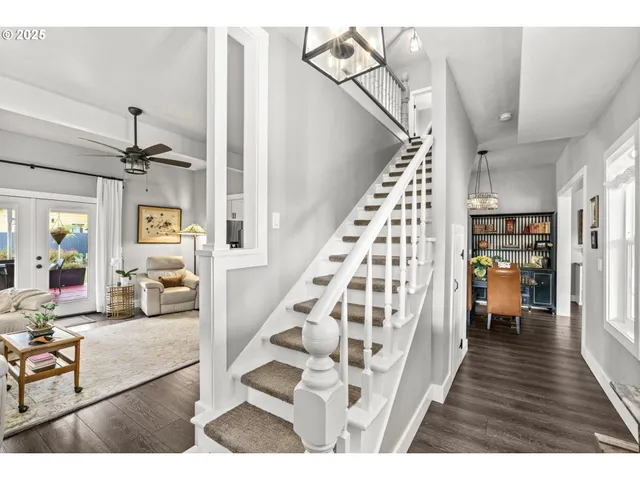 a view of entryway and hall with wooden floor