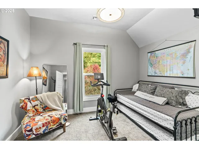 a bedroom with furniture and a large window