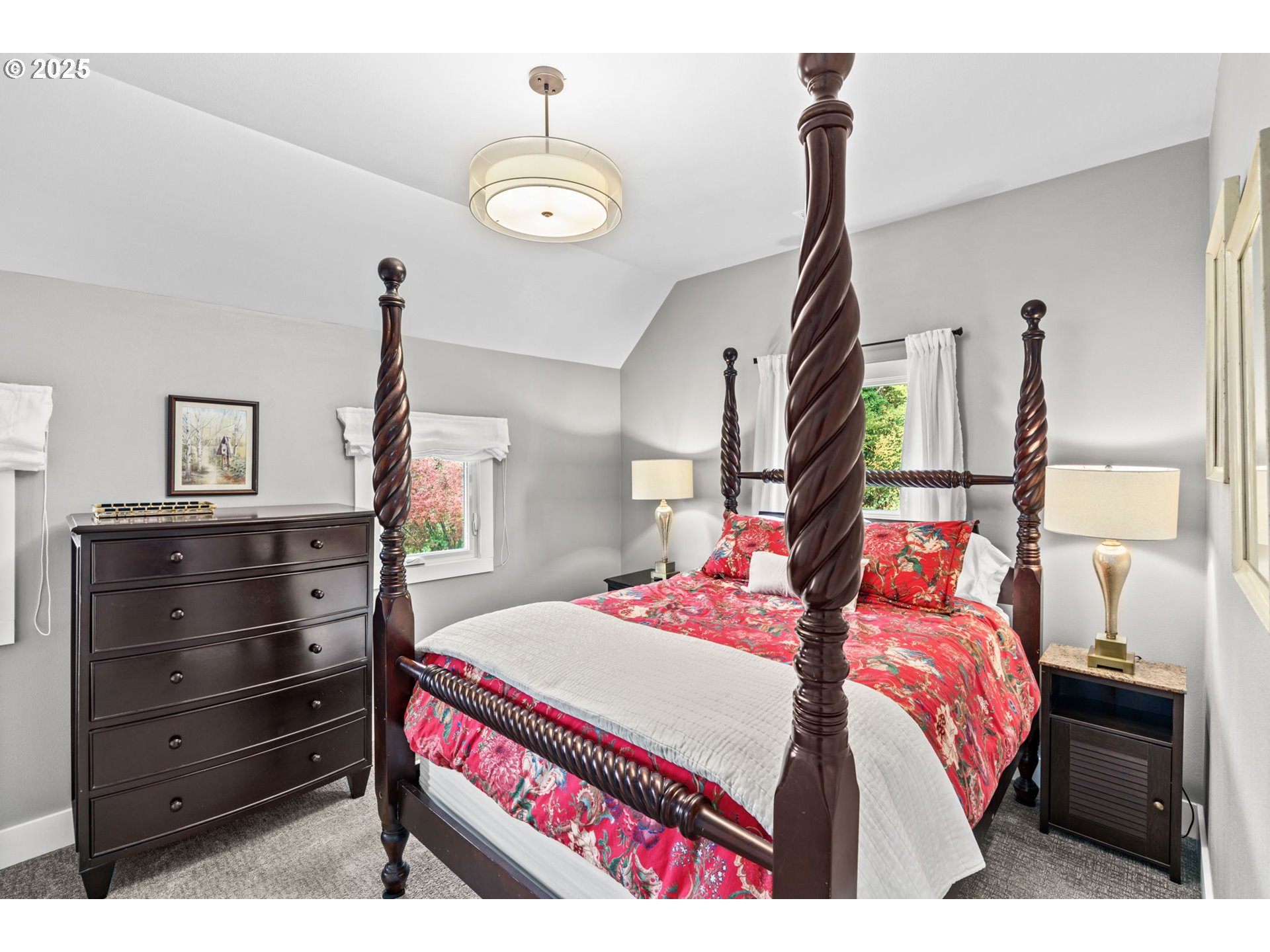 335 North H Street Cottage Grove, OR 97424 - Photo 27 of 45 a bedroom with a bed and a chandelier