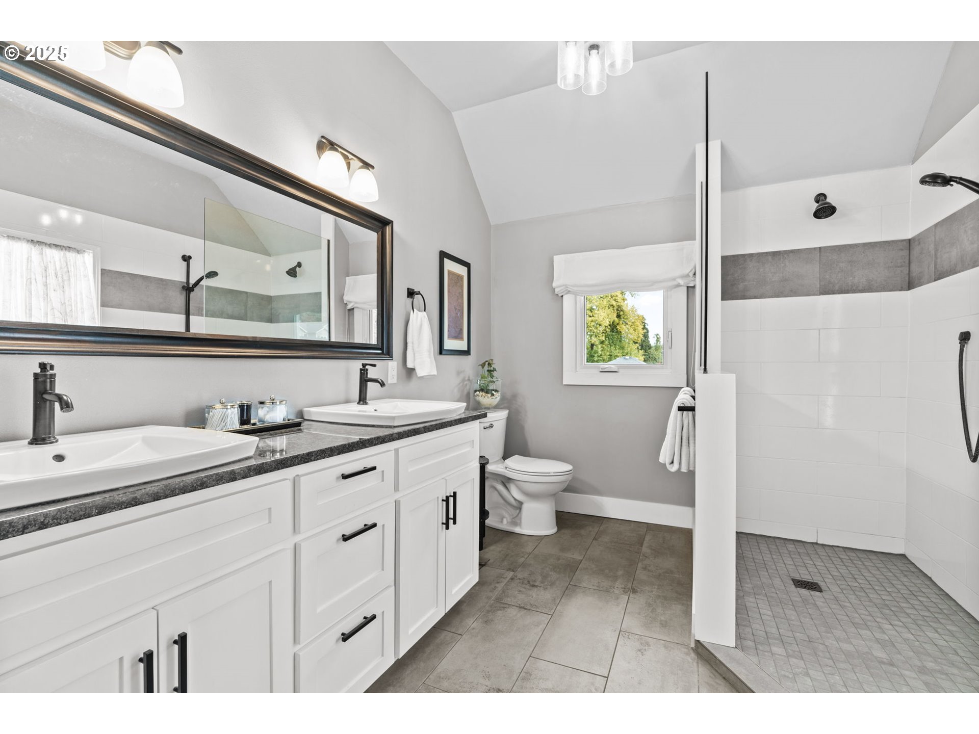 335 North H Street Cottage Grove, OR 97424 - Photo 32 of 45 a spacious bathroom with a granite countertop sink mirror and toilet