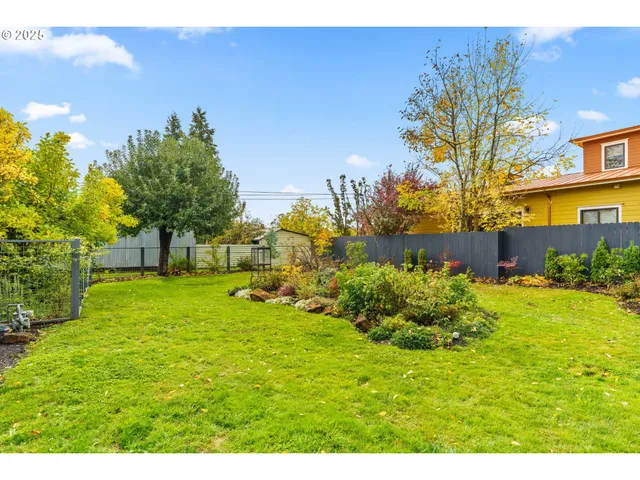 a view of a garden with a building in the background