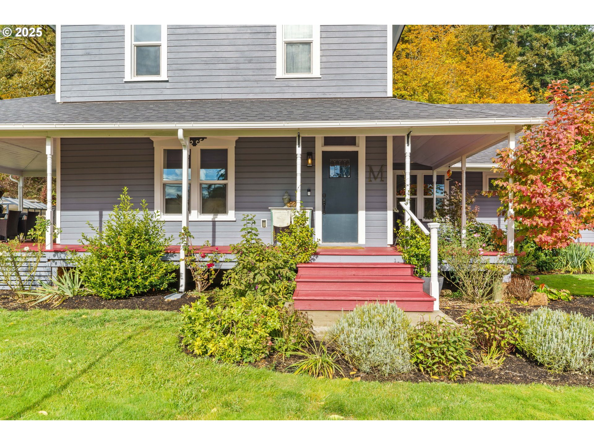 335 North H Street Cottage Grove, OR 97424 - Photo 5 of 45 a front view of a house with a yard and potted plants