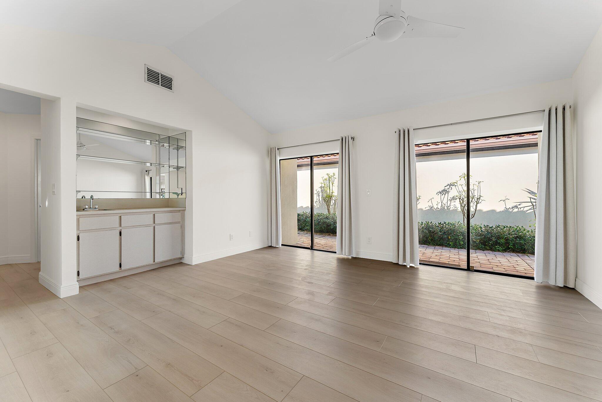 1483 Vía Del Sol Jupiter, FL 33477 - Photo 11 of 23 an empty room with wooden floor and windows