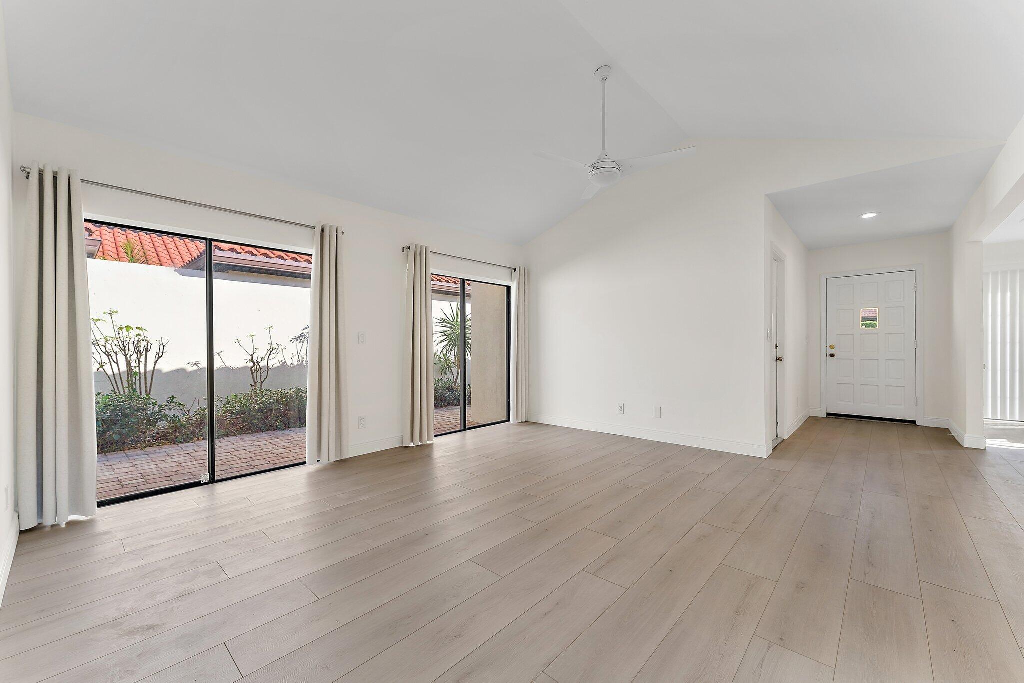 1483 Vía Del Sol Jupiter, FL 33477 - Photo 12 of 23 an empty room with wooden floor and windows