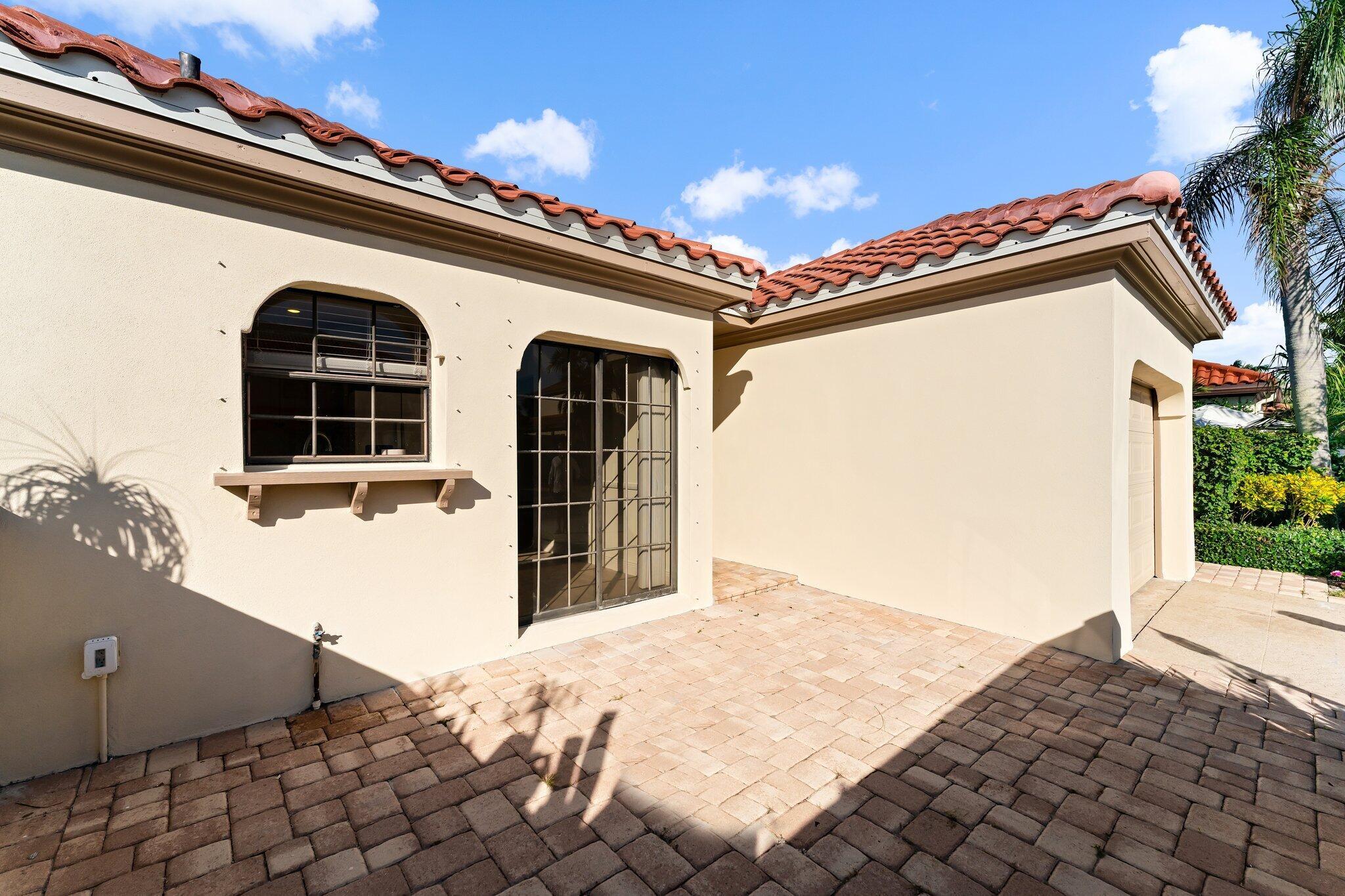 1483 Vía Del Sol Jupiter, FL 33477 - Photo 4 of 23 a front view of a house with a yard