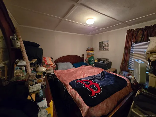 a bedroom with furniture and a closet