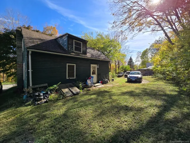 a view of house with backyard space and garden