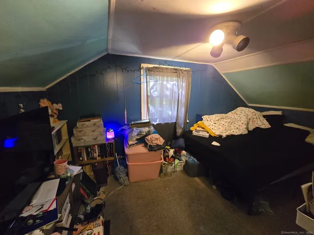 a living room with furniture and a lamp