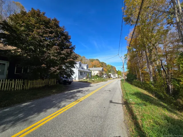 a view of a yard with iron fence