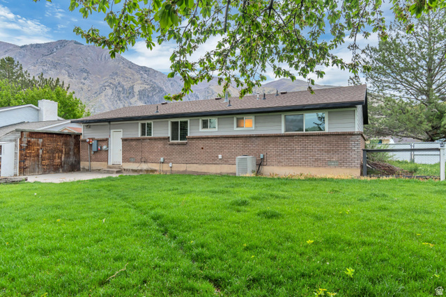 495 North 250 West Springville, UT 84663 - Photo 27 of 35 Back of property with brick siding, a patio, a mountain view, and an outdoor structure