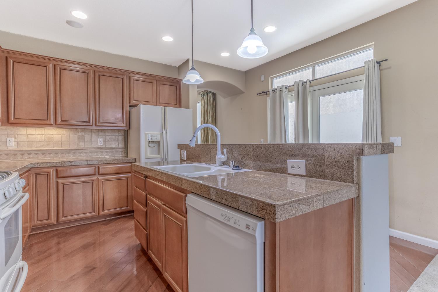 188 Thomsen Road Lathrop, CA 95330 - Photo 15 of 27 a kitchen with a sink stove and cabinets