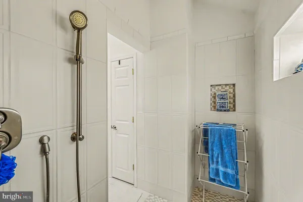 a bath room with painting and flowers