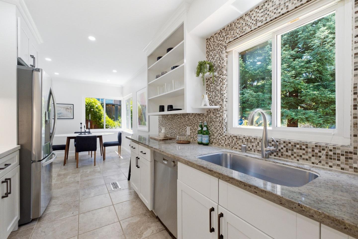 9858 Golf Links Road Oakland, CA 94605 - Photo 6 of 39 a kitchen with granite countertop a sink and counter space