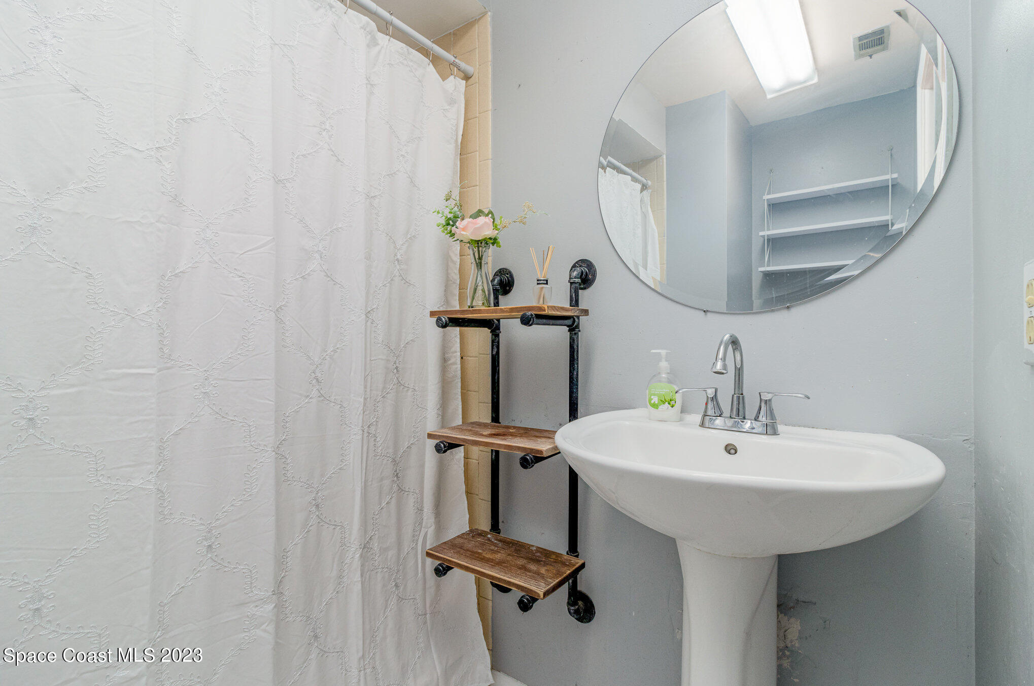 649 Croton Road Melbourne, FL 32935 - Photo 12 of 22 a bathroom with a sink and mirror