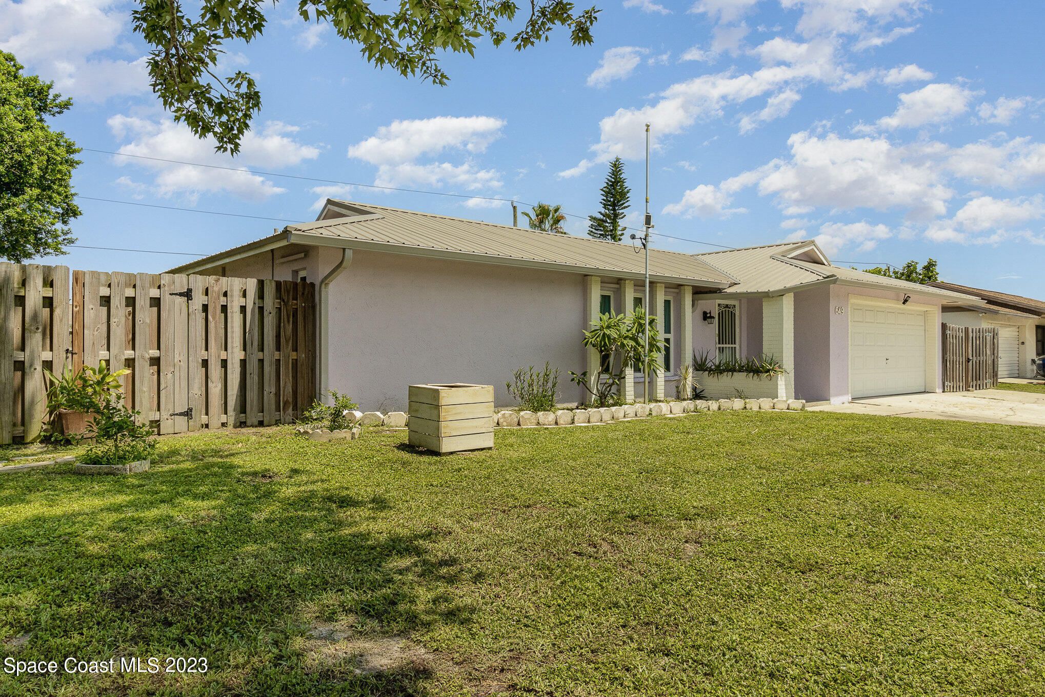 649 Croton Road Melbourne, FL 32935 - Photo 3 of 22 a front view of a house with garden
