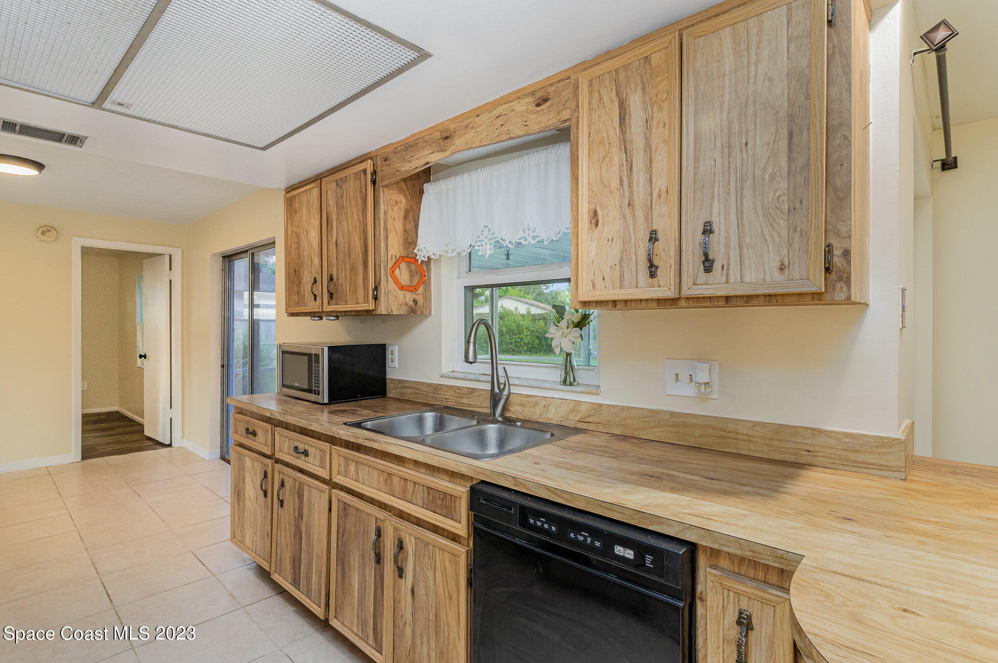 649 Croton Road Melbourne, FL 32935 - Photo 8 of 22 a kitchen with stainless steel appliances granite countertop a sink stove and cabinets