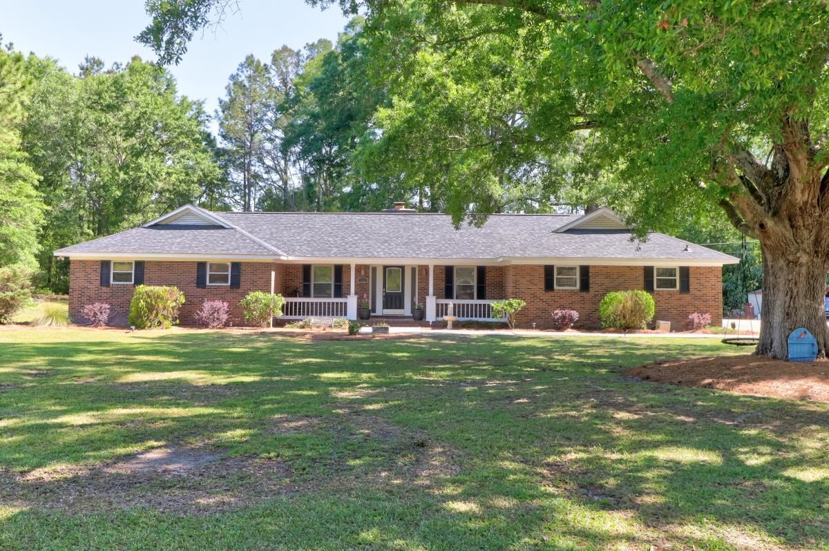 116 Miles Pembroke, GA 31321 - Photo 1 of 1 a front view of a house with a garden