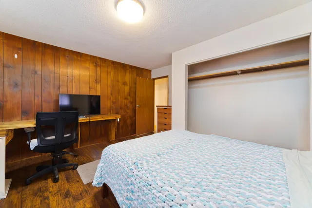 a bedroom with a bed and a desk