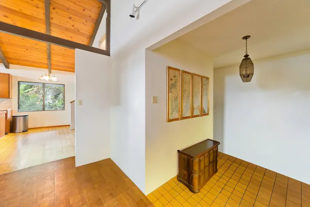 an empty room with floor to ceiling windows and city view