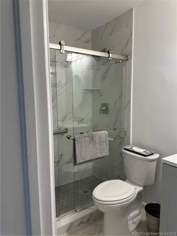 a white toilet sitting next to a bathroom sink