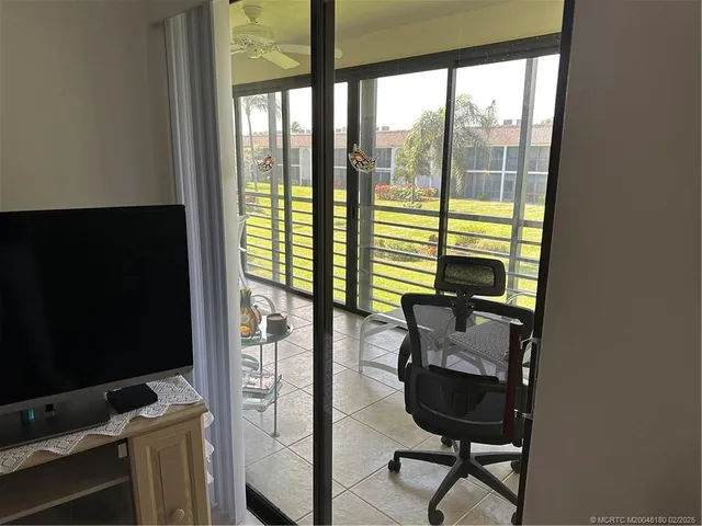 a view of work space with wooden floor and windows