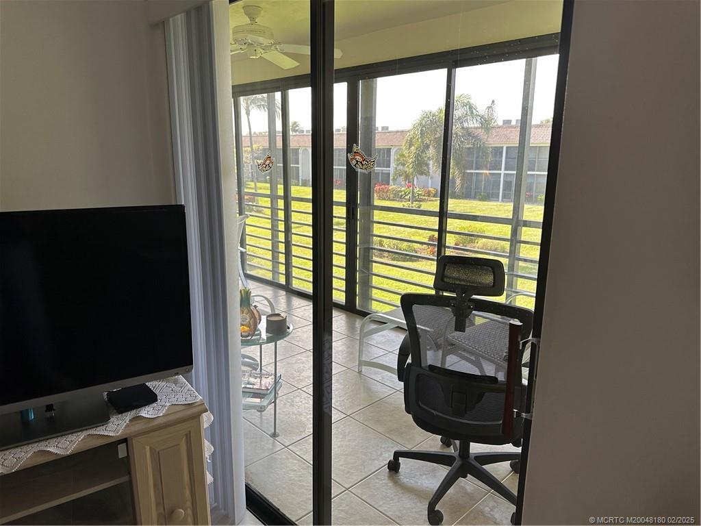 755 Saturn Street, Unit F205 Jupiter, FL 33477 - Photo 15 of 19 a view of work space with wooden floor and windows