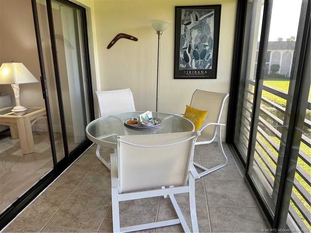 755 Saturn Street, Unit F205 Jupiter, FL 33477 - Photo 9 of 19 a white table sitting next to a window