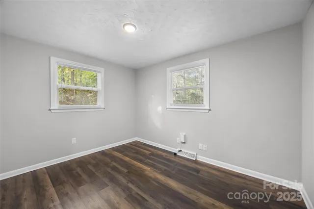 an empty room with wooden floor and closet