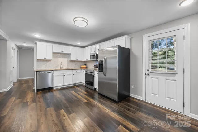 a kitchen with a sink stove and microwave