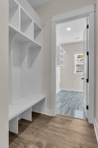 wooden floor with view of bathroom