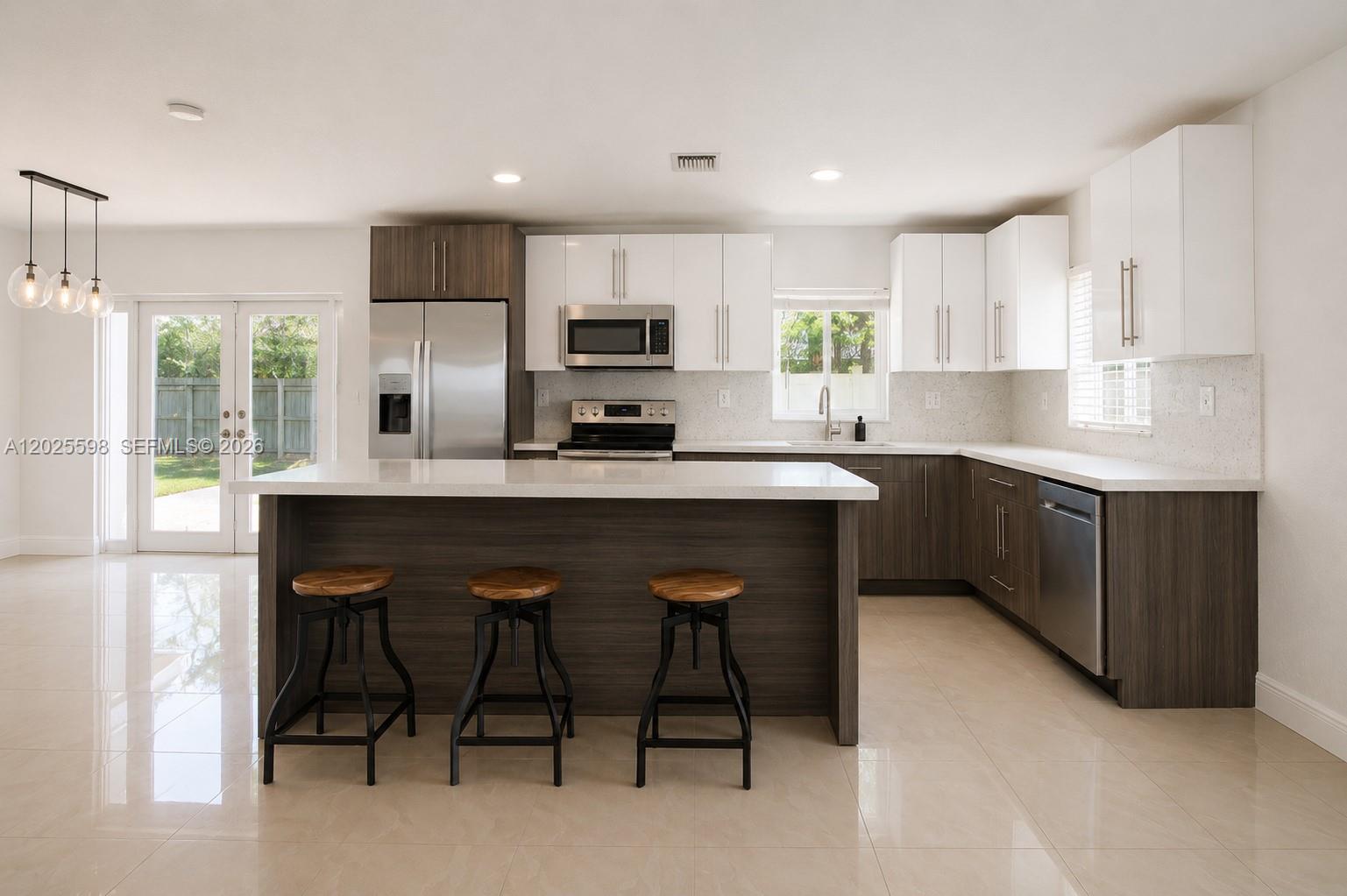 9421 Southwest 150th Street Miami, FL 33176 - Photo 10 of 31 a kitchen with appliances a sink cabinets and a counter top space