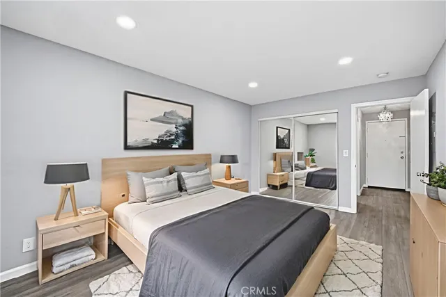 a bedroom with a large bed and a lamp