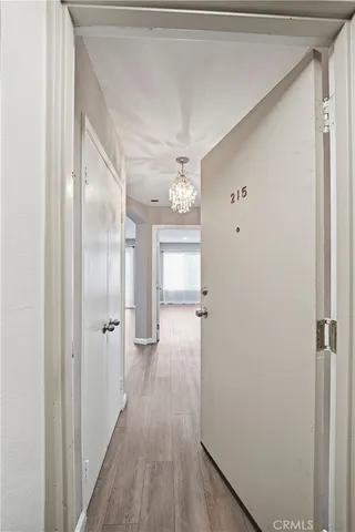 a view of hallway with wooden floor