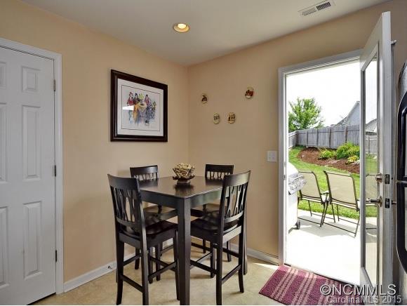 91 West Swift Creek Road Fletcher, NC 28732 - Photo 2 of 14 a view of a dining room with furniture a chandelier and wooden floor