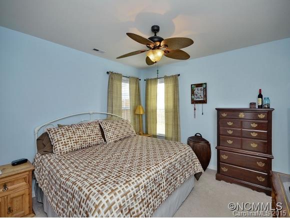 91 West Swift Creek Road Fletcher, NC 28732 - Photo 11 of 14 a bedroom with a bed and a chandelier