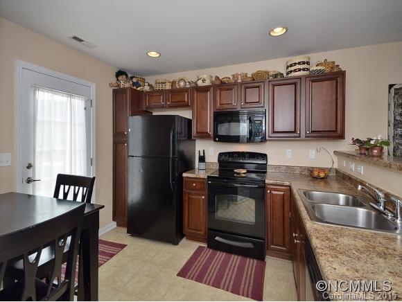 91 West Swift Creek Road Fletcher, NC 28732 - Photo 6 of 14 a kitchen with granite countertop a refrigerator stove and sink