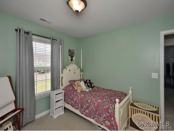 91 West Swift Creek Road Fletcher, NC 28732 - Photo 8 of 14 a bedroom with a bed and wooden floor
