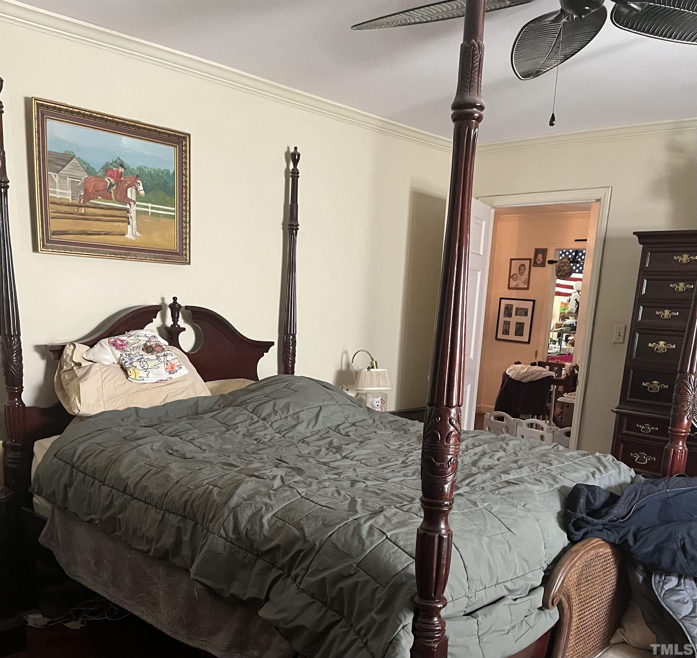 929 Deerfield Road Raleigh, NC 27609 - Photo 6 of 6 a bedroom with a bed and a dresser
