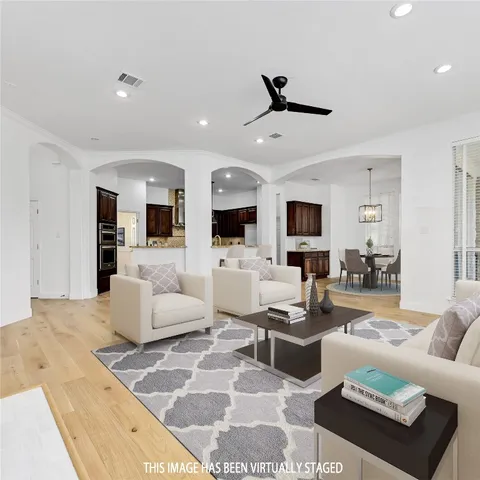 a living room with furniture flat screen tv and white walls
