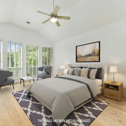 a bedroom with a large bed and a window