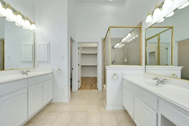 a spacious bathroom with a double vanity sink mirror and double