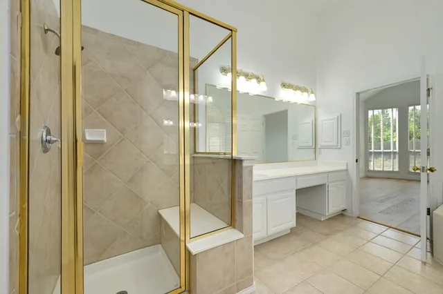 a bathroom with a shower and a sink