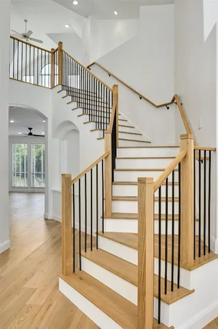 a view of staircase with lots of frames and a rug