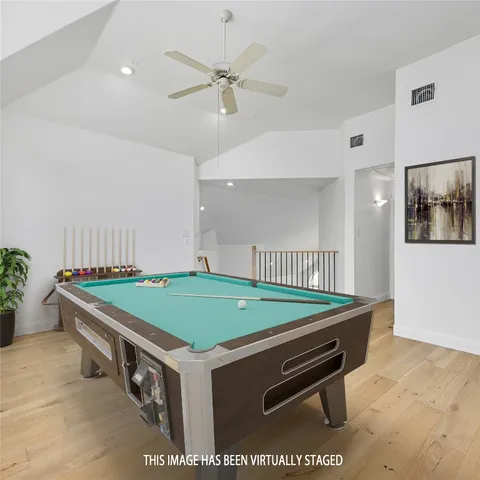 a room with pool table and a chandelier