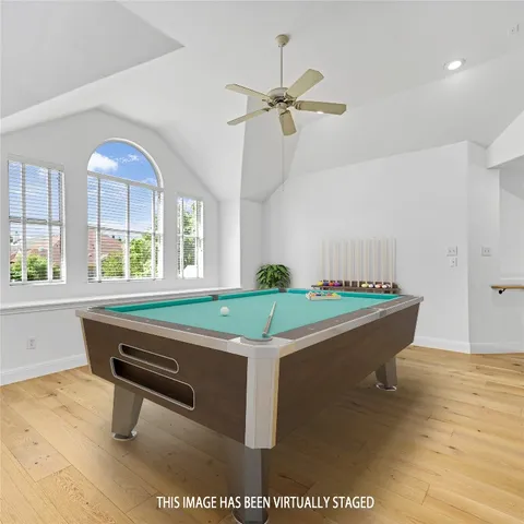 a room with pool table and windows