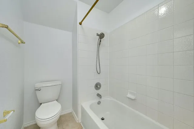 a bathroom with a toilet and a bath tub