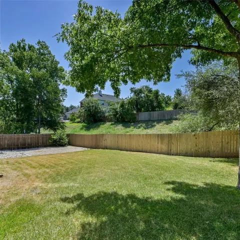 a view of small yard with wooden fence